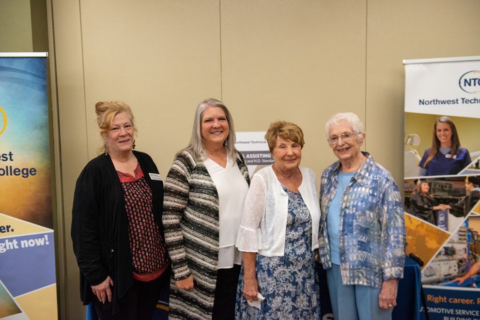Current and former dental assisting faculty pose for a photo