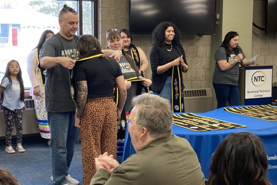 An NTC student is presented with her stole