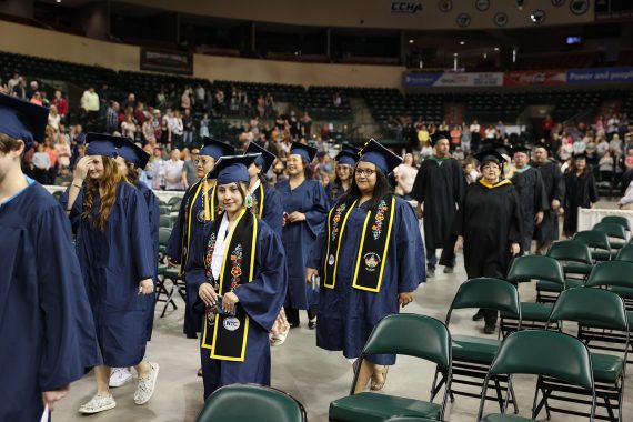 American Indian NTC graduates process into the Sanford Center