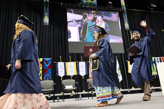 An NTC graduate walks across the stage