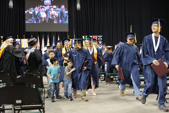 An NTC graduate celebrates with his family