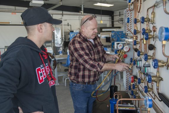NTC students being show HVAC components by an instructor