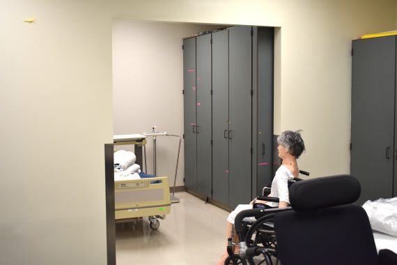 A female mannequin sits in a wheelchair outside of the entrance to the Sanford/NTC Health Sciences Lab for CNA students at Bemidji High School.