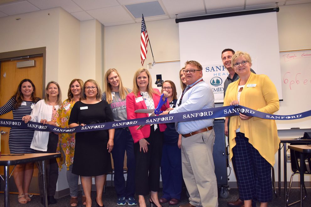 Representatives from NTC, Bemidji High School and Sanford Health unveil the Sanford/NTC Health Sciences Lab for CNA students at Bemidji High School.