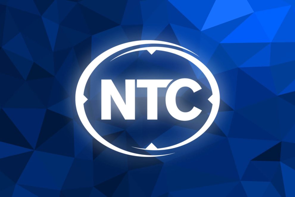 NTC's logo in white against a background of many triangles in different colors of blue