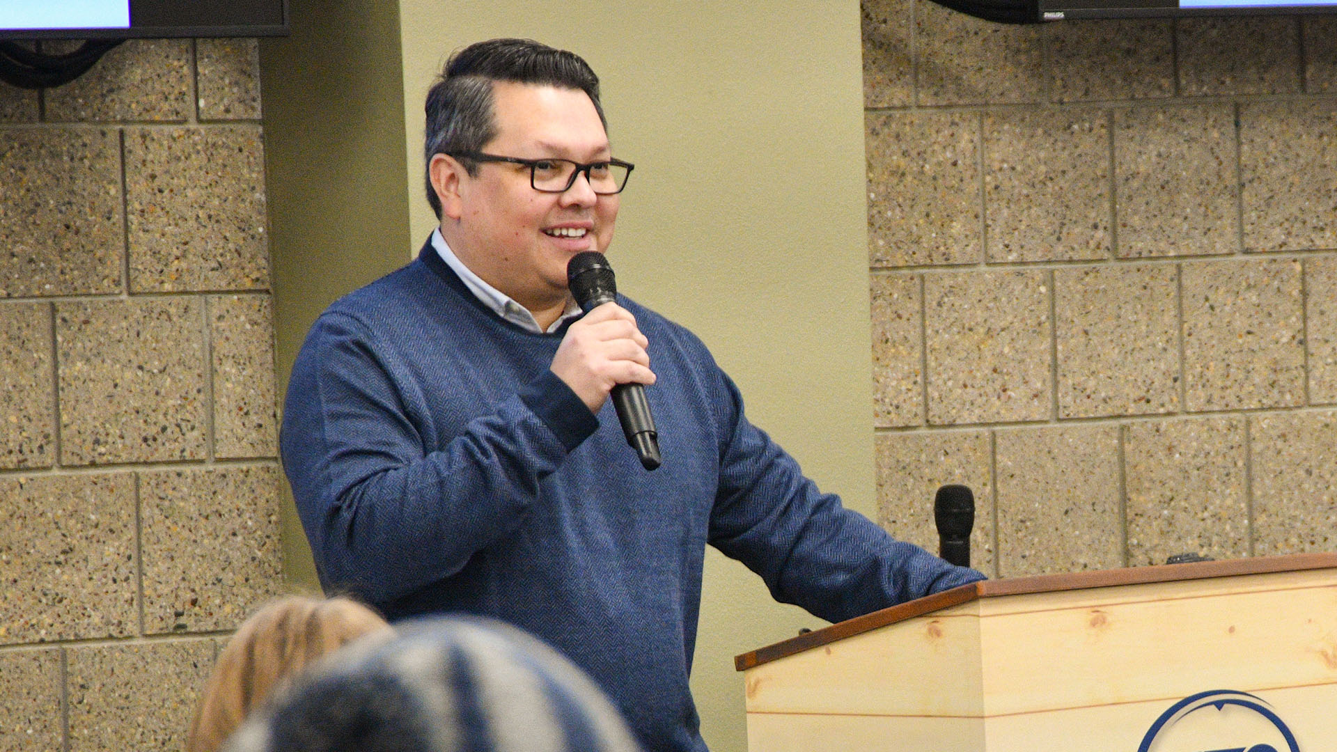Henoc Preciado, head of staff for NTC's Office of the President and NTC Foundation director, speaks into a microphone.